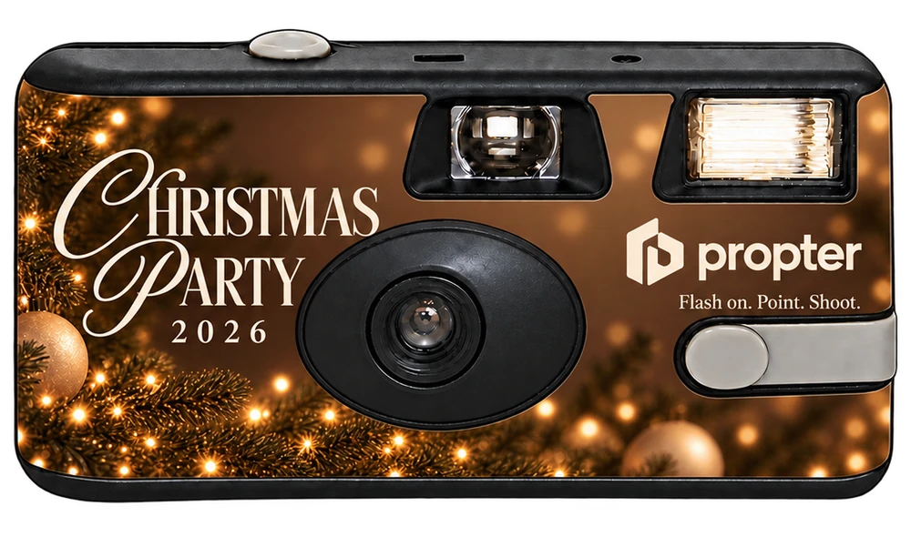 Front of a disposable camera: a warm, glowing Christmas Party 2026 sticker with gold baubles, fairy lights and a company logo