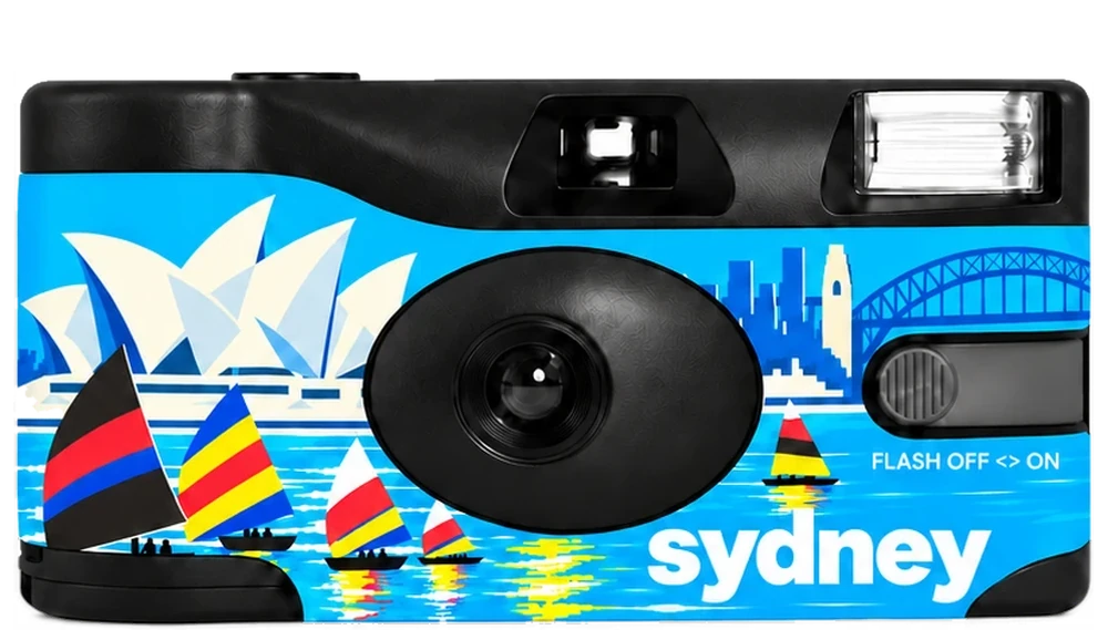 A disposable camera with a bright blue Sydney design with the Opera House, the Harbour Bridge and sailboats