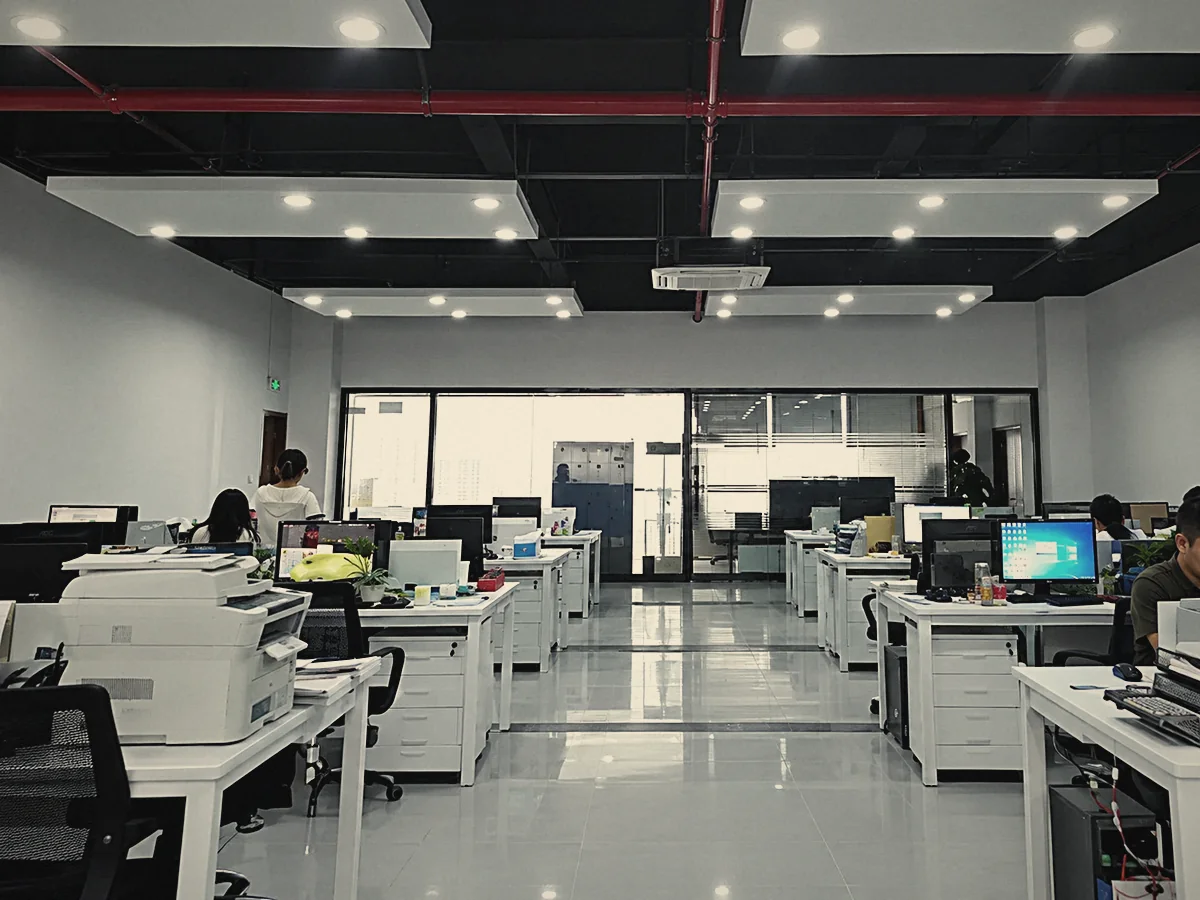The factory&rsquo;s open-plan office, with rows of desks, computers and printers under ceiling lights