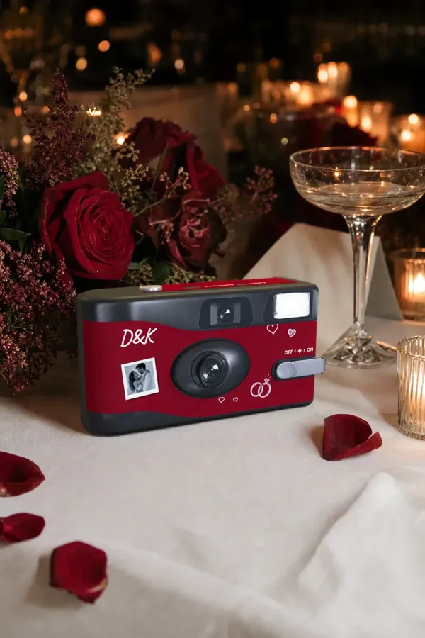 Dylan and Kiara's red camera on a candlelit table