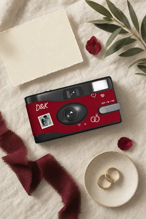 Dylan and Kiara's camera with red ribbon and rings