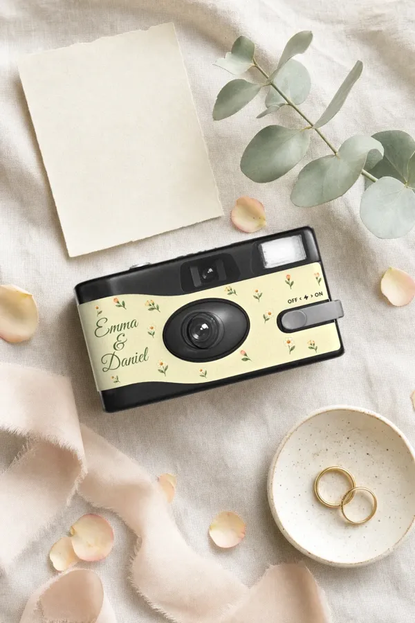 Emma and Daniel's camera on linen with wedding rings